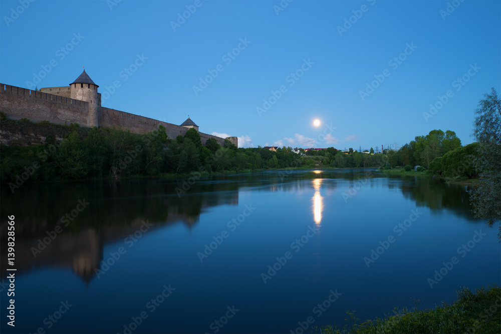 August twilight at the walls of the Ivangorod fortress. Border river Narva, Russia
