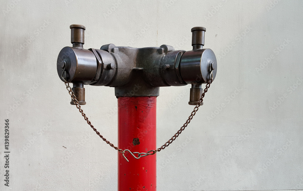 Old red metallic fire hydrant on street