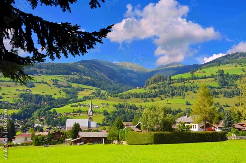 Fotografie Beautiful view of Niedernsill town and surrounding countryside in summer - Zell
