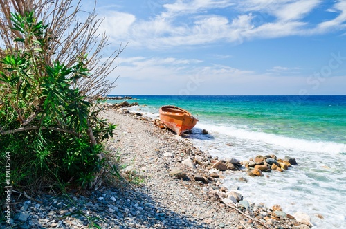 Abandoned orange boat at the beach Platanaki on the aegean island Samos photo