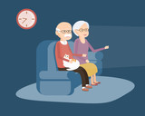 Elderly Couple Sitting on the Sofa and Watching TV