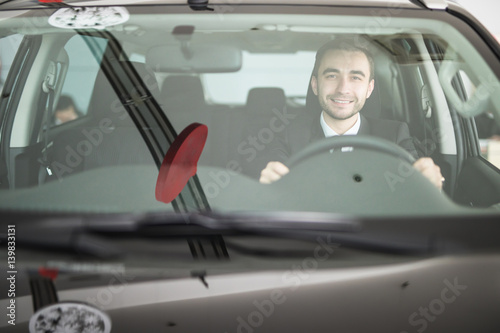 Handsome man driving his car photo