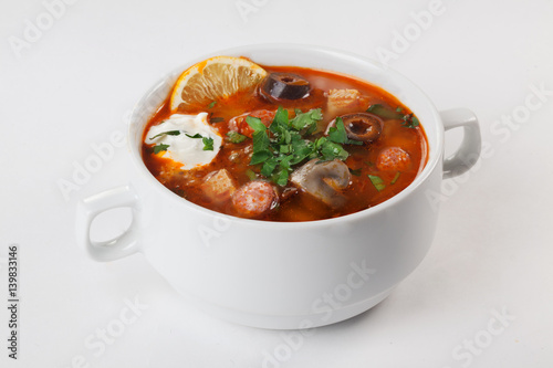 Salsola with sausages and mushrooms in a bowl with pens isolated white background
