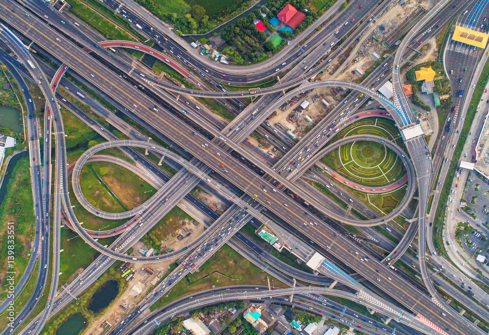 Aerial view Road roundabout. Expressway with car lots in the city in Thailand. Street large beautiful downtown. cityscape. Top view. Aerial view Road roundabout. Expressway with car lots in the city in Thailand. Street large beautiful downtown. cityscape. Top view.