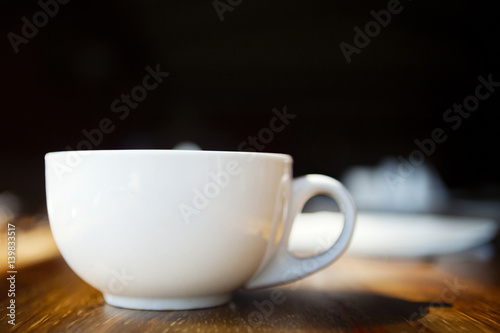  Coffee cup, on wooden table.