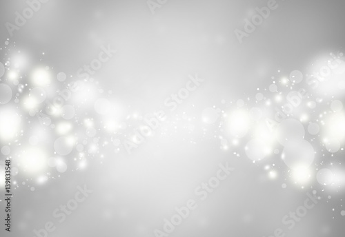 Grey sparkles glitter defocused rays lights bokeh abstract holiday background.