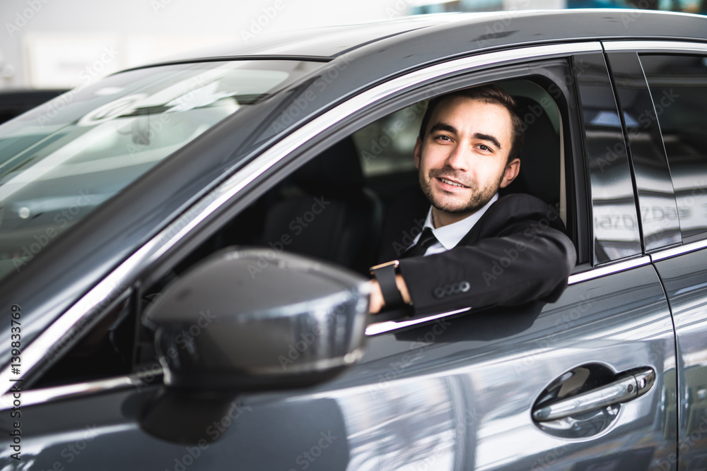 happy smiling driver in the car, portrait of young successful business man happy smiling driver in the car, portrait of young successful business man