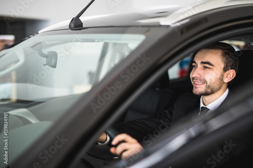 Attractive elegant happy man drive good car
