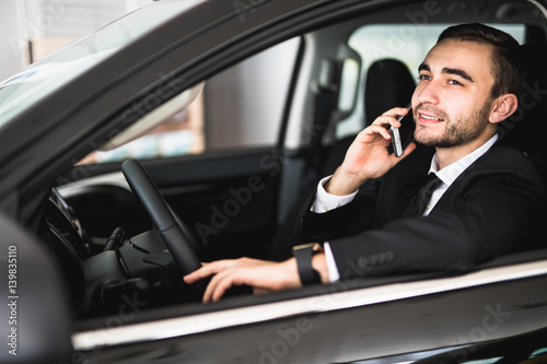 Portrait of handsome business man use phone in car © F8  \ Suport Ukraine