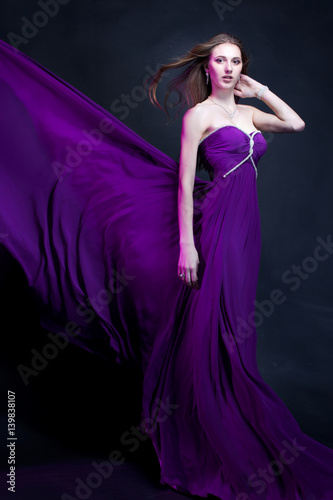 Fashion Woman in violet dress with  Magic Makeup and Hairstyle