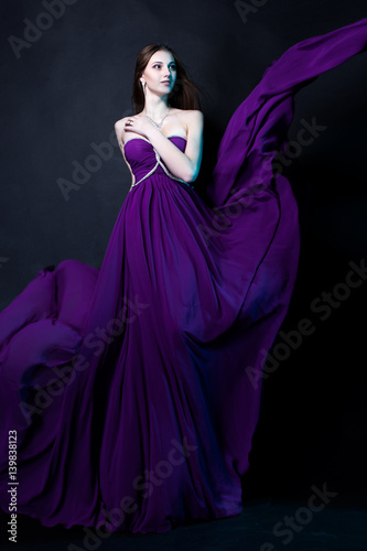 Fashion Woman in violet dress with  Magic Makeup and Hairstyle