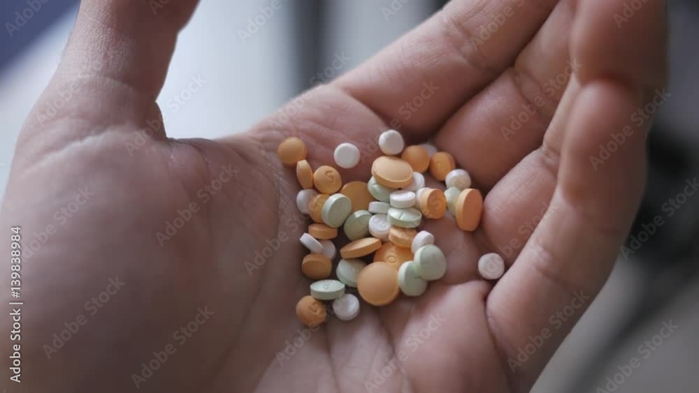 Medication pills in hand opening. Medication pills in hand opening.