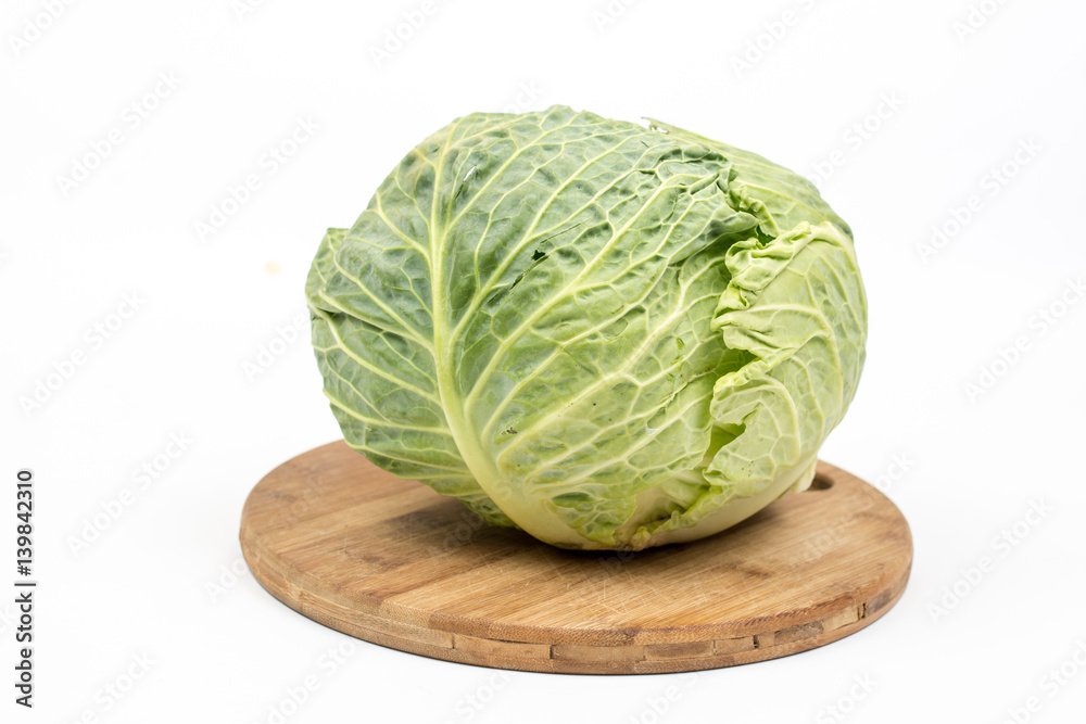 Fototapeta premium Green fresh cabbage on the kitchen wooden board