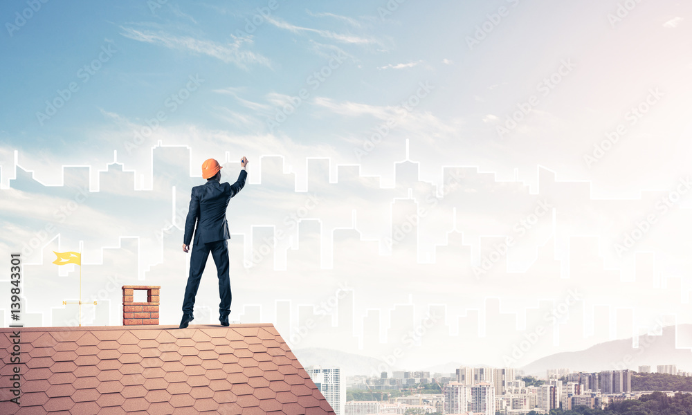 Man architect draw silhouette of modern city on blue sky. Mixed Man architect draw silhouette of modern city on blue sky. Mixed