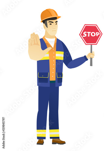 Asian builder holding stop road sign.