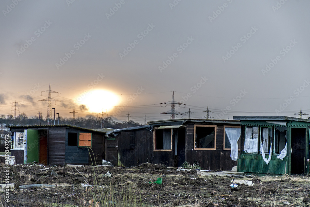 Fototapeta premium Old creepy dark abandoned destructive dirty house broken windows sunset