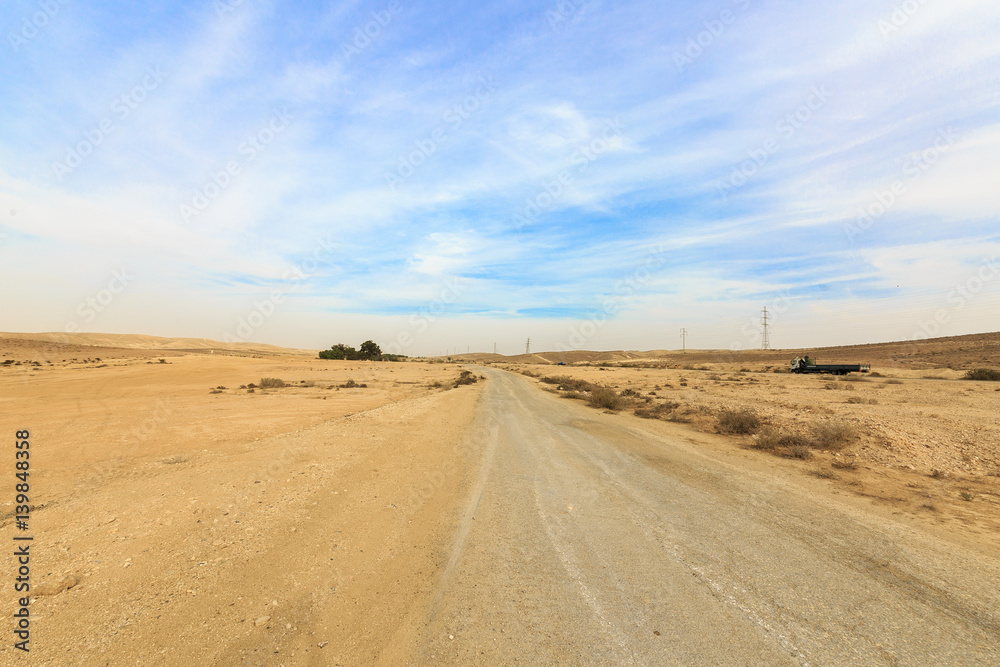 Wide panorama with dirt road in Negev desert