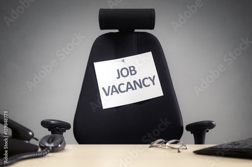 Office chair with job vacancy sign