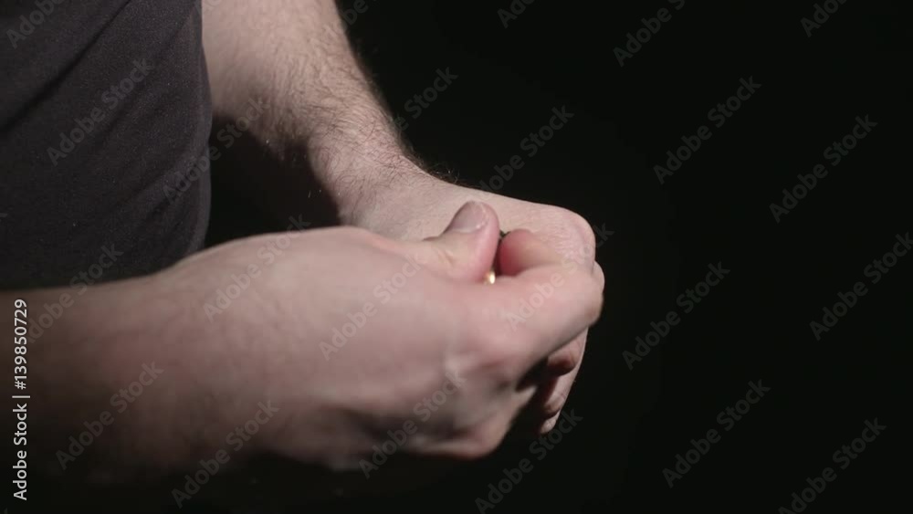Loading a Gun Magazine with Bullets. a close up shot of hands loading a magazine clip with bullets in slow motion
Loading a Gun Magazine with Bullets. a close up shot of hands loading a magazine clip with bullets in slow motion