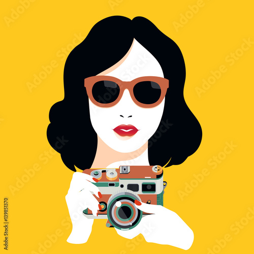 Fashion pretty young smiling woman with retro camera taking photo