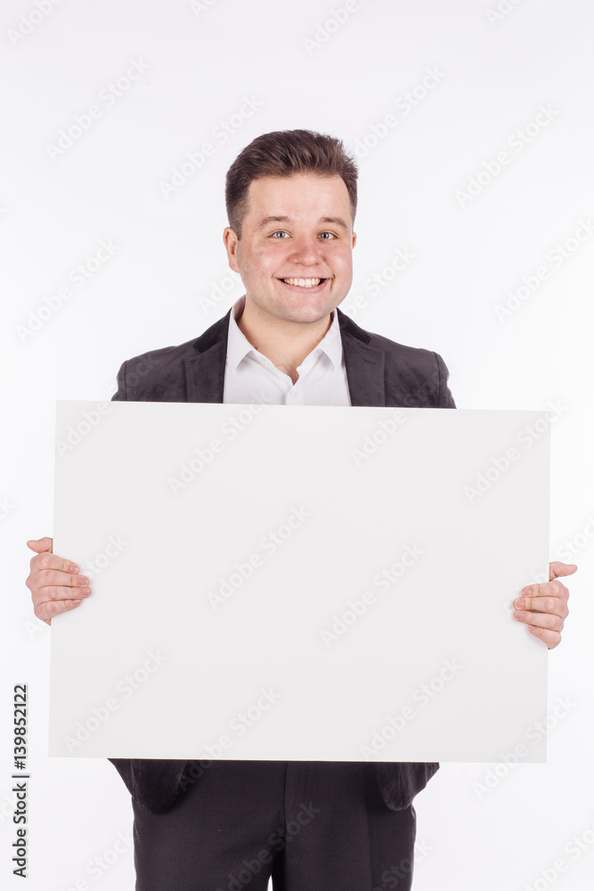 young man holding white blank panel with space for text on white background. young man holding white blank panel with space for text on white background.