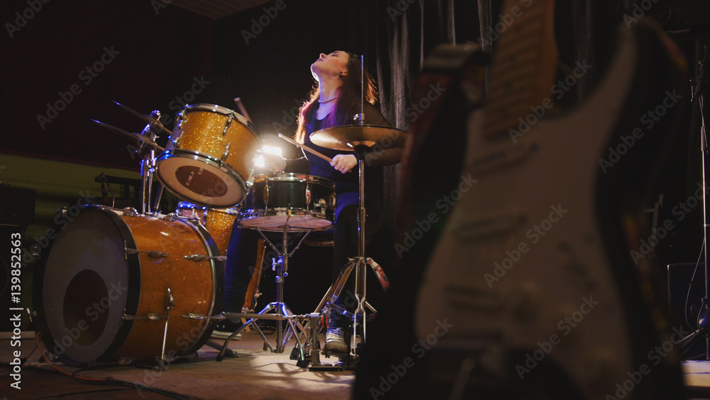 Naklejka premium Hard rock music - drum break down performing - attractive girl with flowing hair