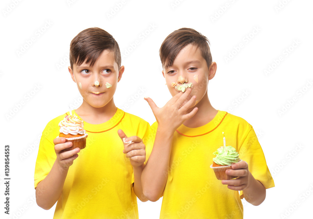 Cute boys with birthday cupcakes on white background Cute boys with birthday cupcakes on white background