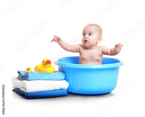 Cute baby in plastic basin,...