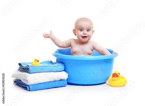 Cute baby in plastic basin,...