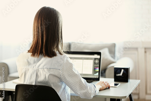 Woman working on computer a...