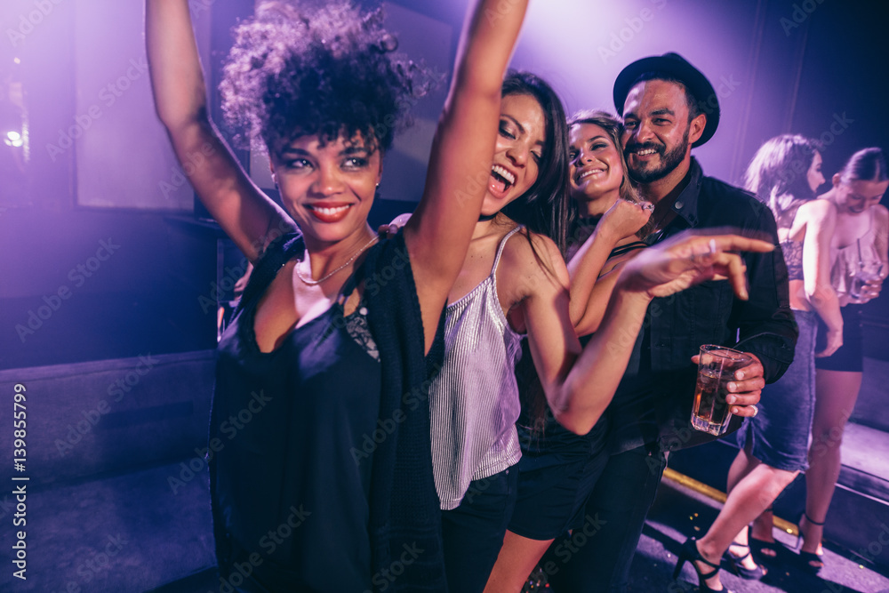 Friends dancing in night club Friends dancing in night club
