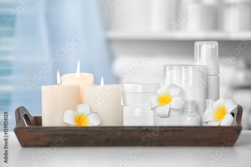 Wooden tray with beautiful spa composition on blurred background