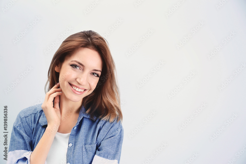 Young beautiful woman on light background Young beautiful woman on light background