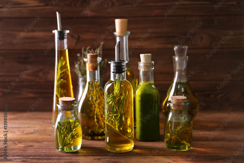 Composition of bottles with oil on wooden background