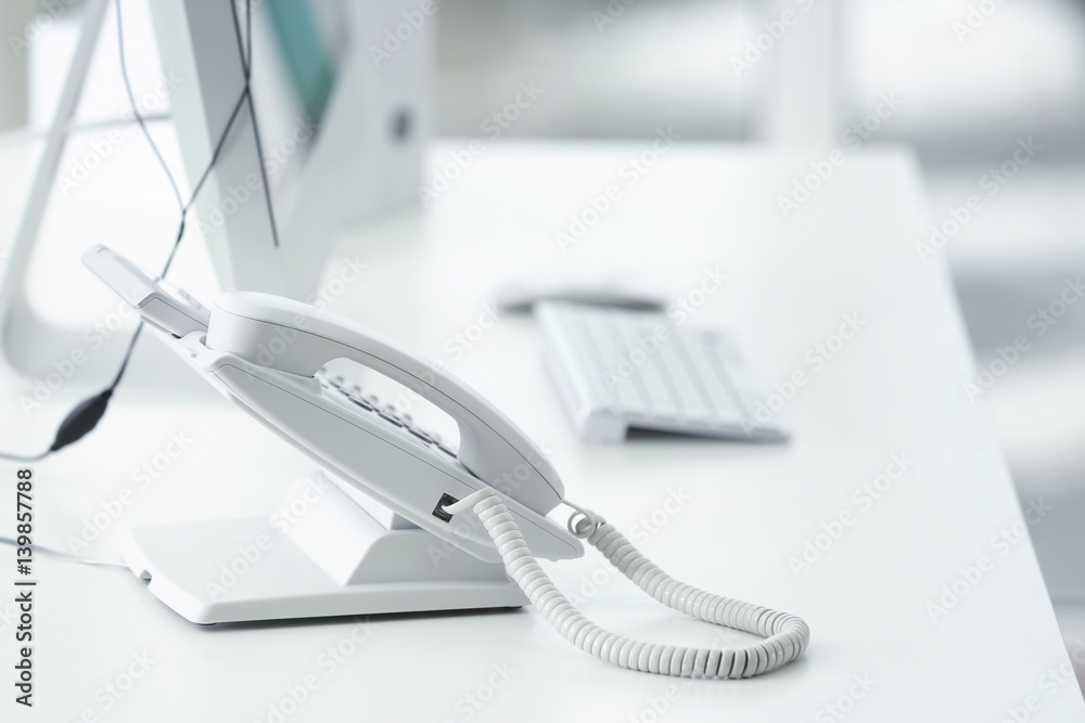 Telephone at workplace of technical support agent in office Telephone at workplace of technical support agent in office