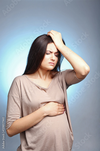 Young pregnant woman suffer...