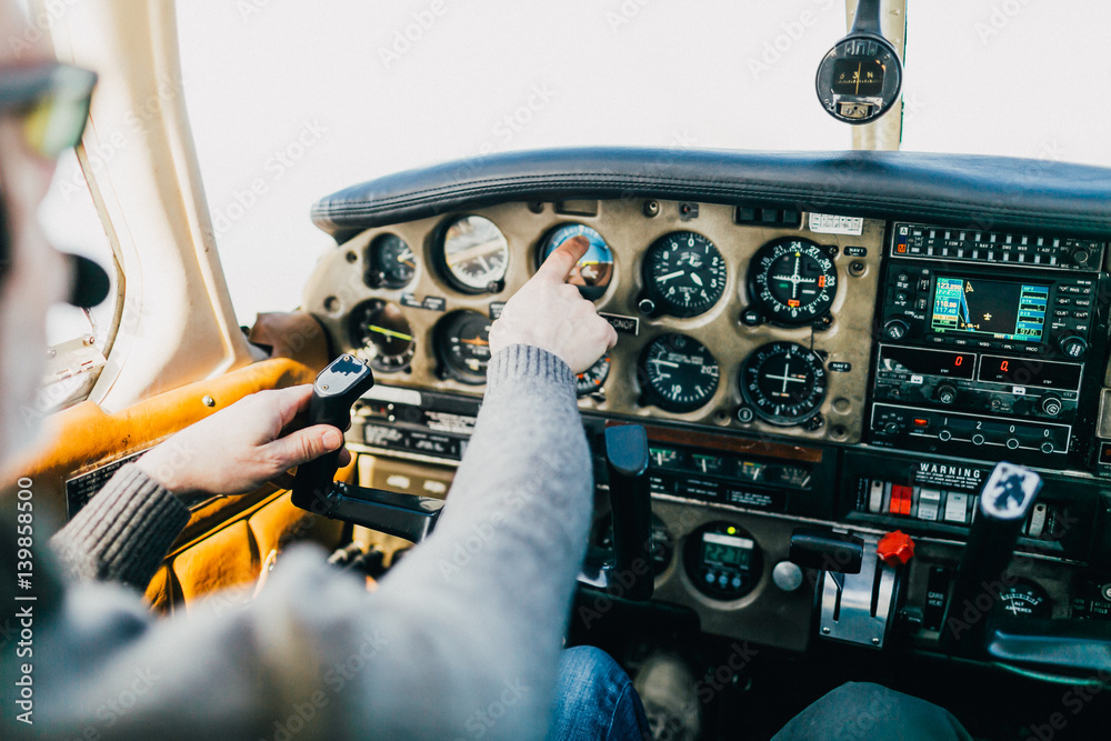 Fotografie Flight instructor and student inside small Piper aircraft