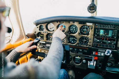 Flight instructor and student inside small Piper aircraft