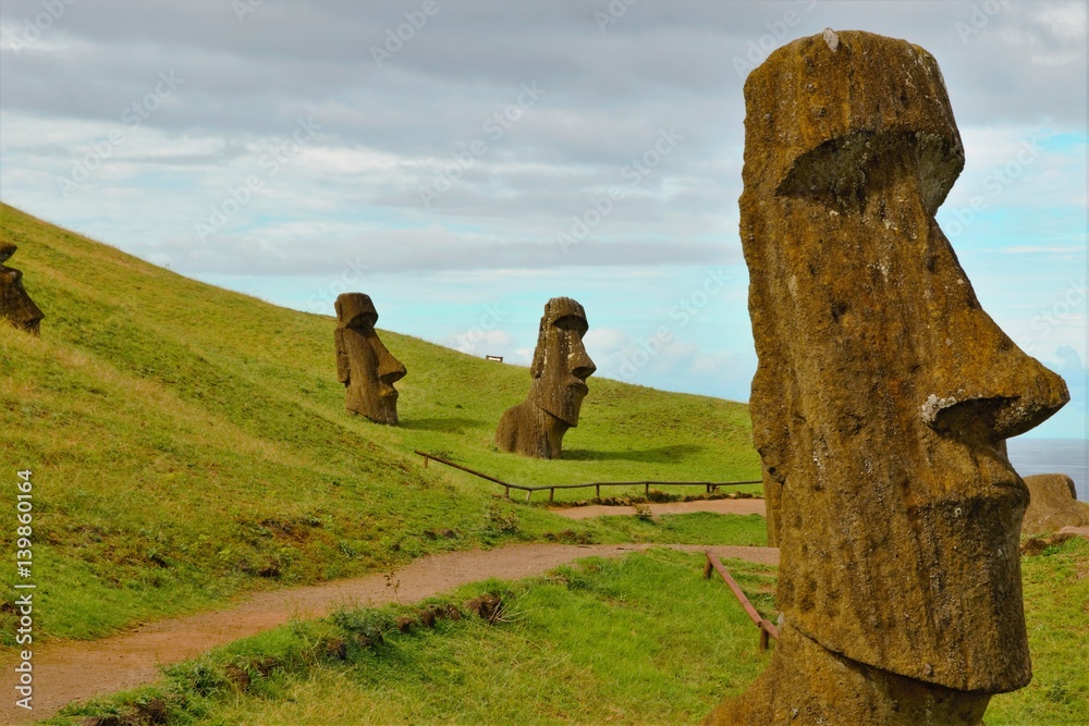 Long shot of Moai statues at the famous Moai statue quarry around the Rano Raraku volcano in