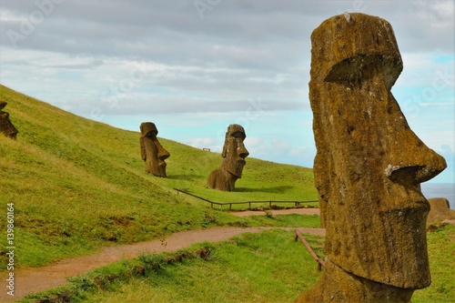 Long shot of Moai statues at the famous Moai statue quarry around the Rano Raraku volcano in Easter Island, Rapa Nui, Chile, South America