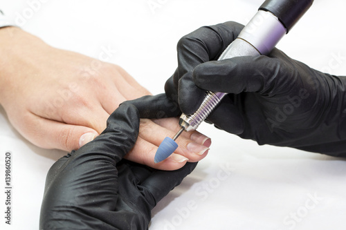 Woman hands doing manicure beauty salon close-up