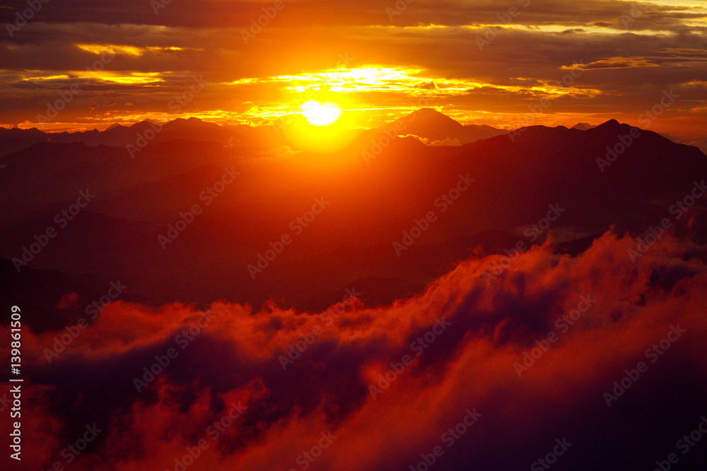 Orange sunset above mountain in valley Himalayas mountains Orange sunset above mountain in valley Himalayas mountains