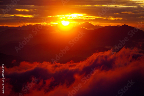 Orange sunset above mountain in valley Himalayas mountains