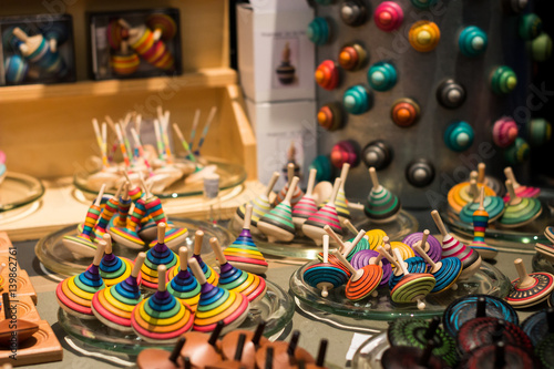 Schilderij op canvas Market stall full of wooden spinning tops