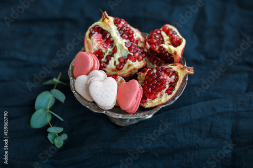 Macaroons and pomegranate in an ancient bowl