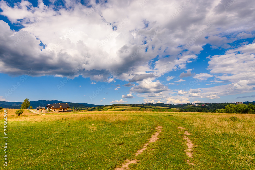 Picturesque rural landscape in summer day with amazing clouds on the sky. Pieniny mountains, Poland. Picturesque rural landscape in summer day with amazing clouds on the sky. Pieniny mountains, Poland.