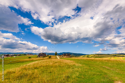 Picturesque rural landscape in summer day with amazing clouds on the sky. Pieniny mountains, Poland.