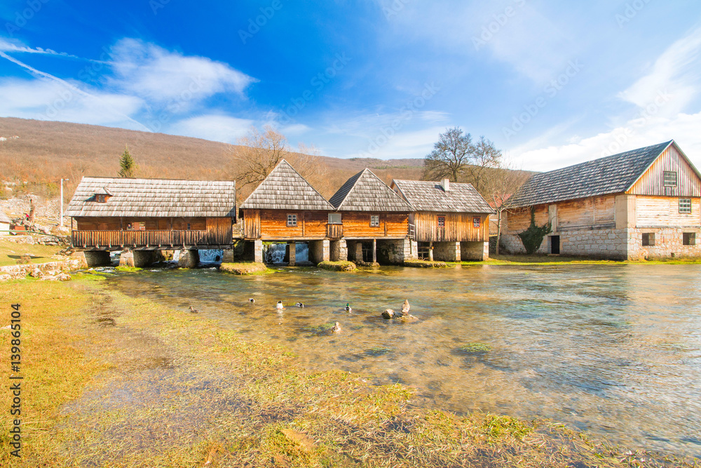 Old wooden water mills in on Majerovo vrilo, source of Gacka river, Lika, Croatia Old wooden water mills in on Majerovo vrilo, source of Gacka river, Lika, Croatia