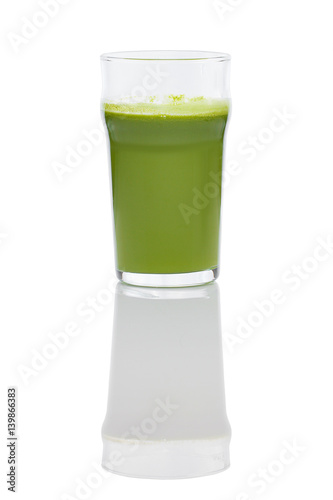Glass of fresh kiwi, celery and apple juice with reflection on white background