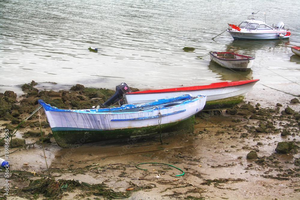 fishing boats moored on the shore of the sea fishing boats moored on the shore of the sea